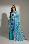 A woman models a three-piece traditional outfit consisting of a light blue and turquoise watercolor-print kurta, matching wide-leg trousers, and a coordinating printed dupatta with blue floral motifs and a white border, set against a minimalist beige background with a wooden panel.